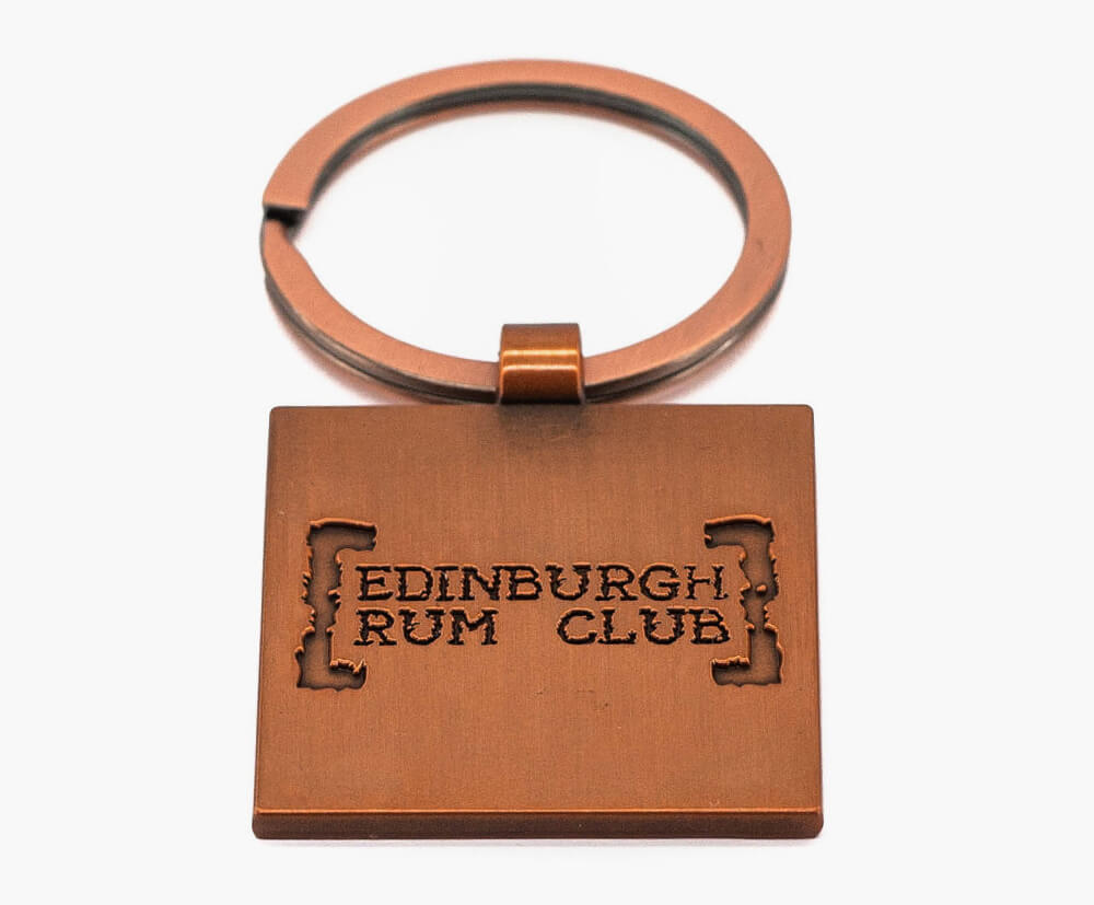 2d (flat) example of a antique copper plated keyring, embossed with logo & details.