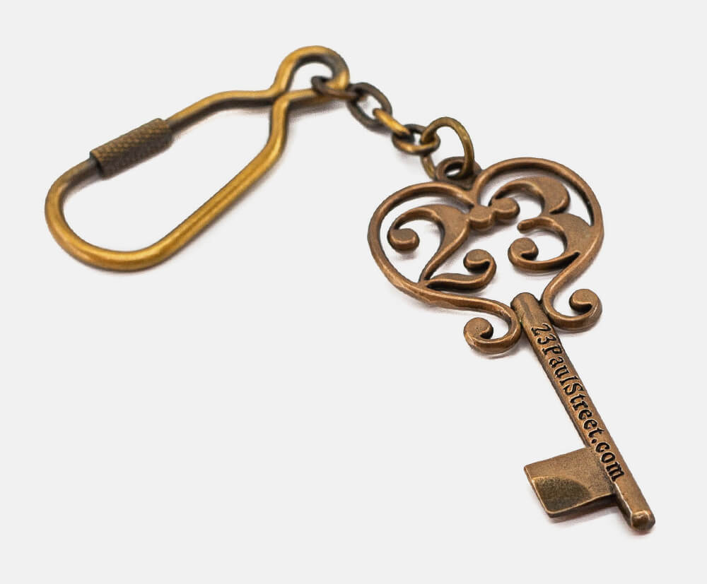 Antique gold plated keyring with embossed branding.
