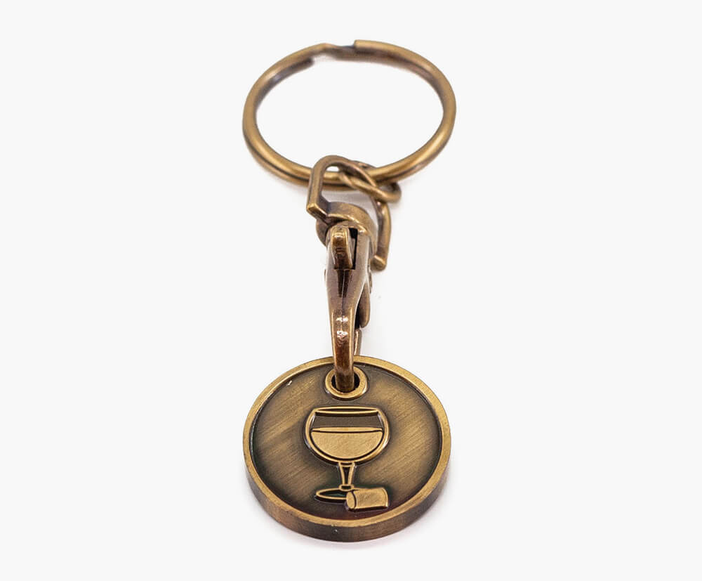 Coin-shaped keyring with antique gold plating.