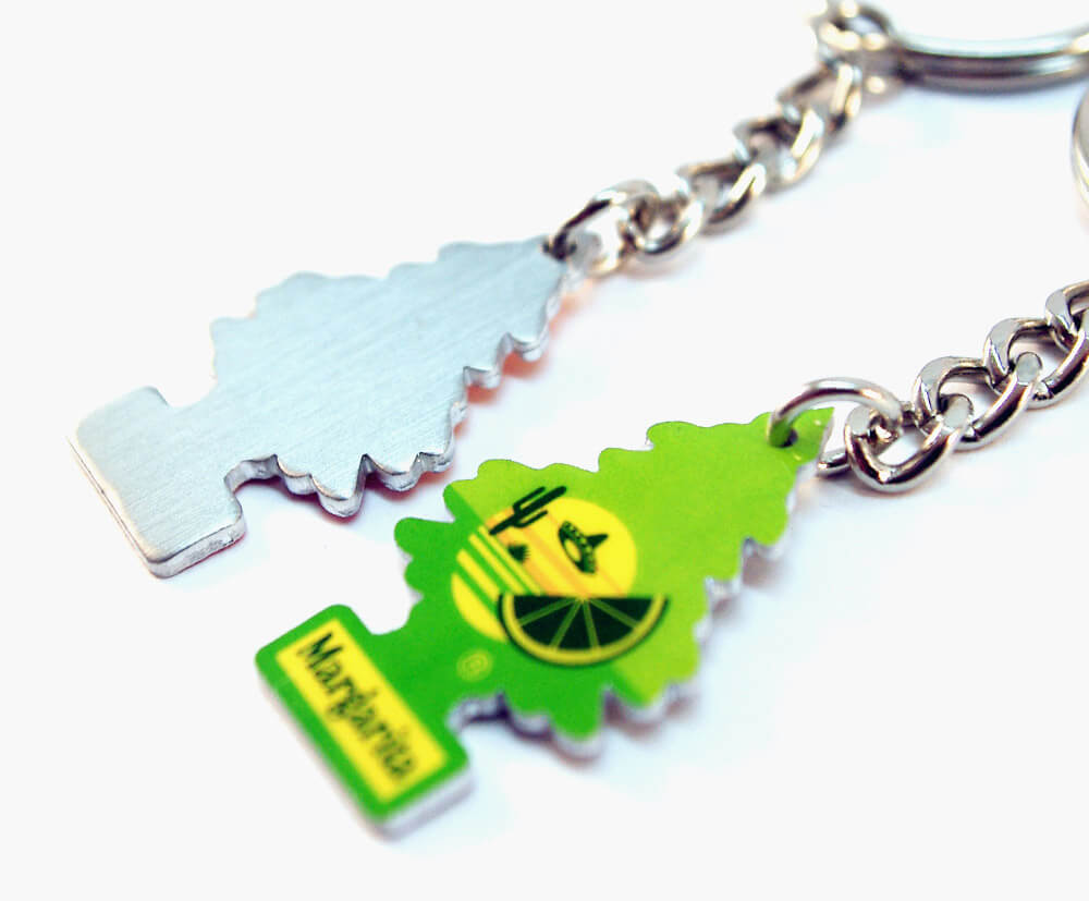 Custom-shaped metal keyring with printed branding on front and unbranded reverse.