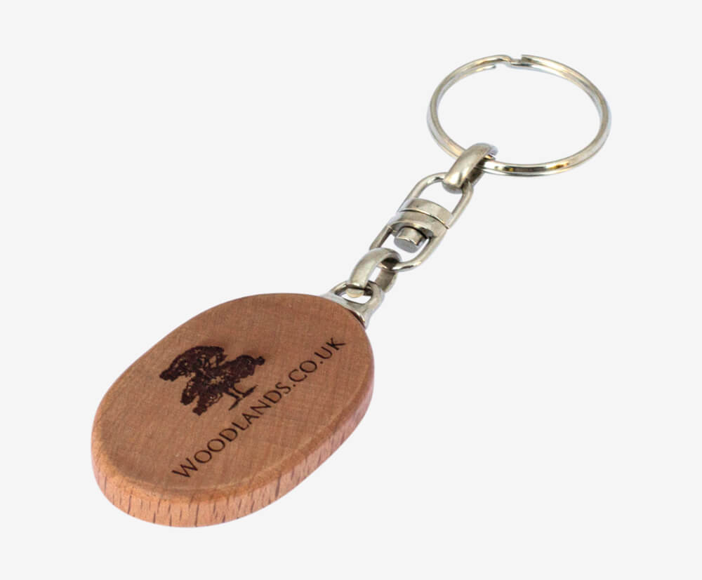 Custom promotional keyring, oval-shaped made from sustainable wood and engraved with logo.