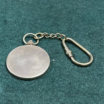Solid brass circular keyring with blank reverse side for custom engraving, attached via chain and carabiner clip.