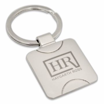 Custom square metal keyring with engraved branding.