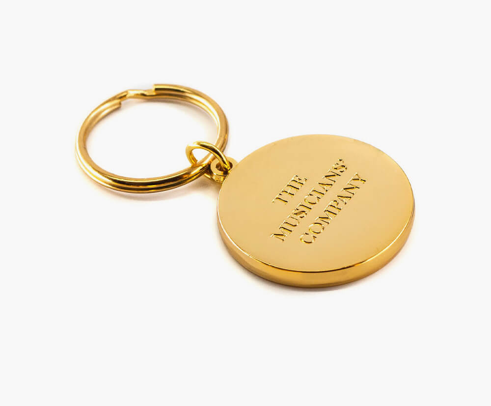 Embossed branding on a custom metal keyring with gold plating.