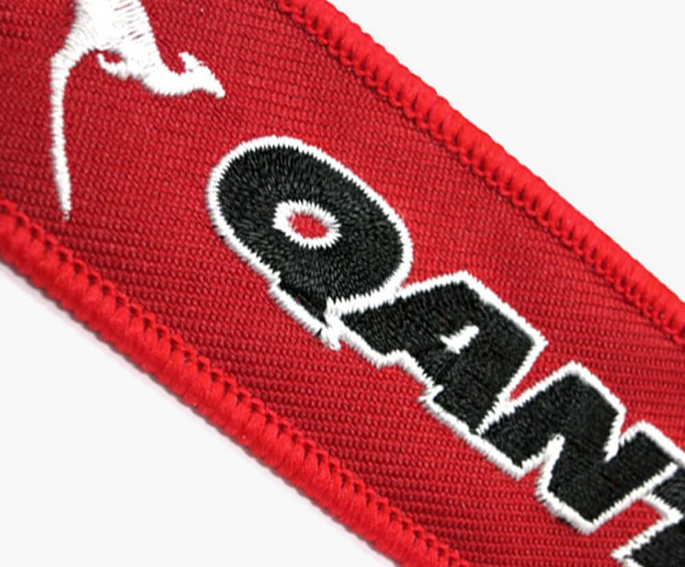 Example of embroidered details on the remove before flight keytags