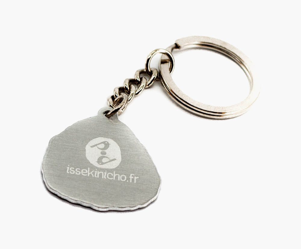Custom-shaped metal keyring with an engraved branding on the back.