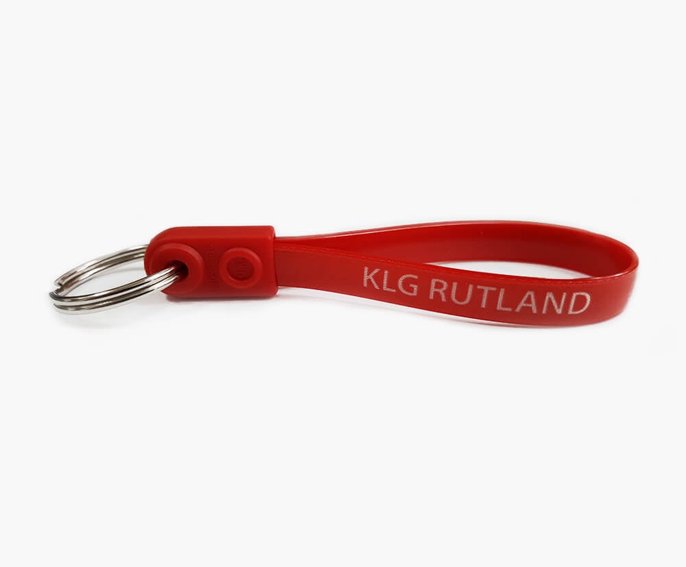 Red fooded  print on a white ribbon on a customisable ad-loop keyring.