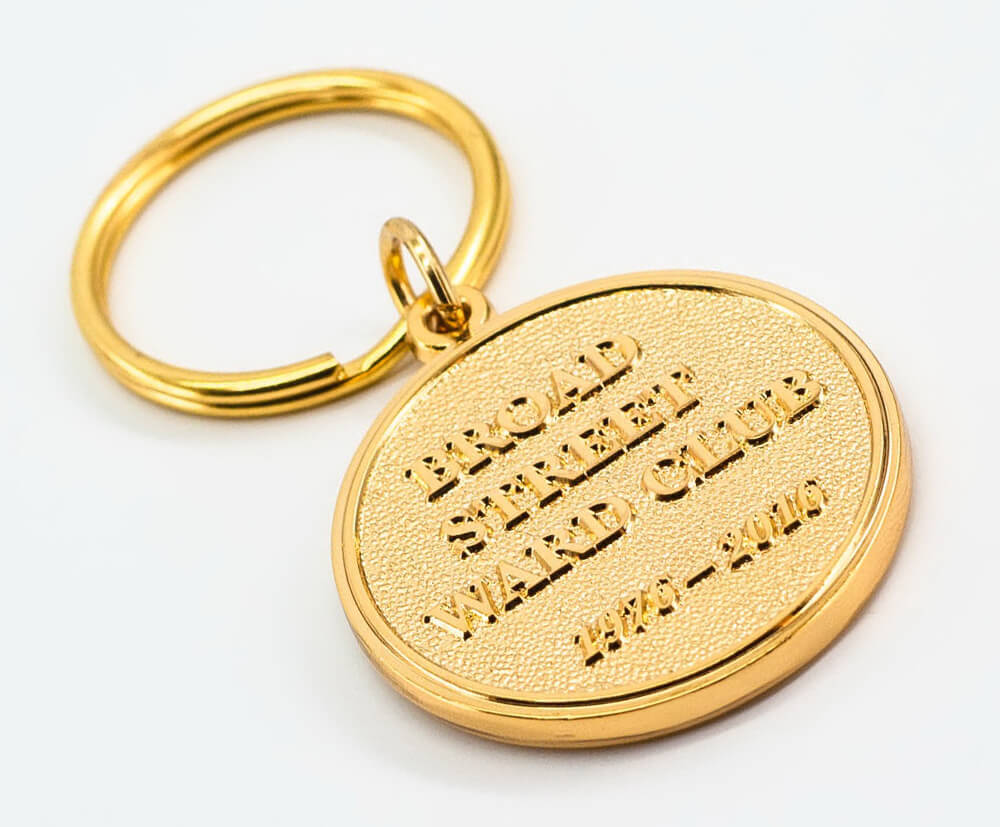 Gold embossed keyrings with details on the front.