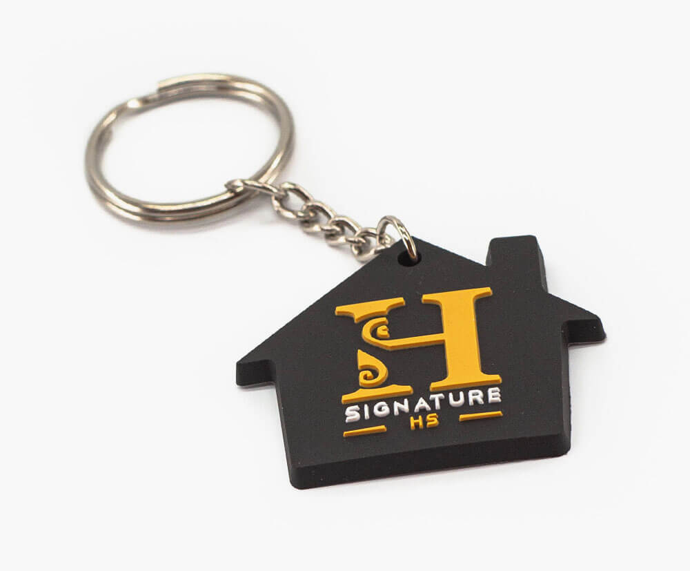 Dark medium sized house shaped keychain with 3 colour PVC fill. Chain attachment.