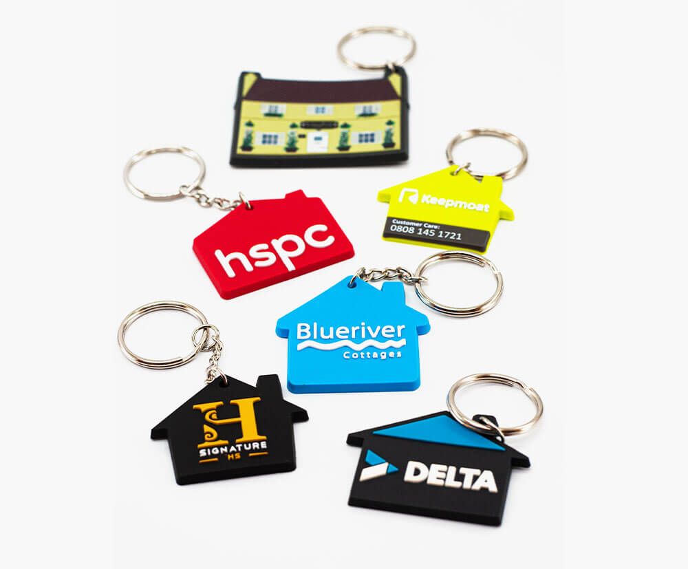 Selection of personalised soft PVC house shaped keyrings. Any shape available.