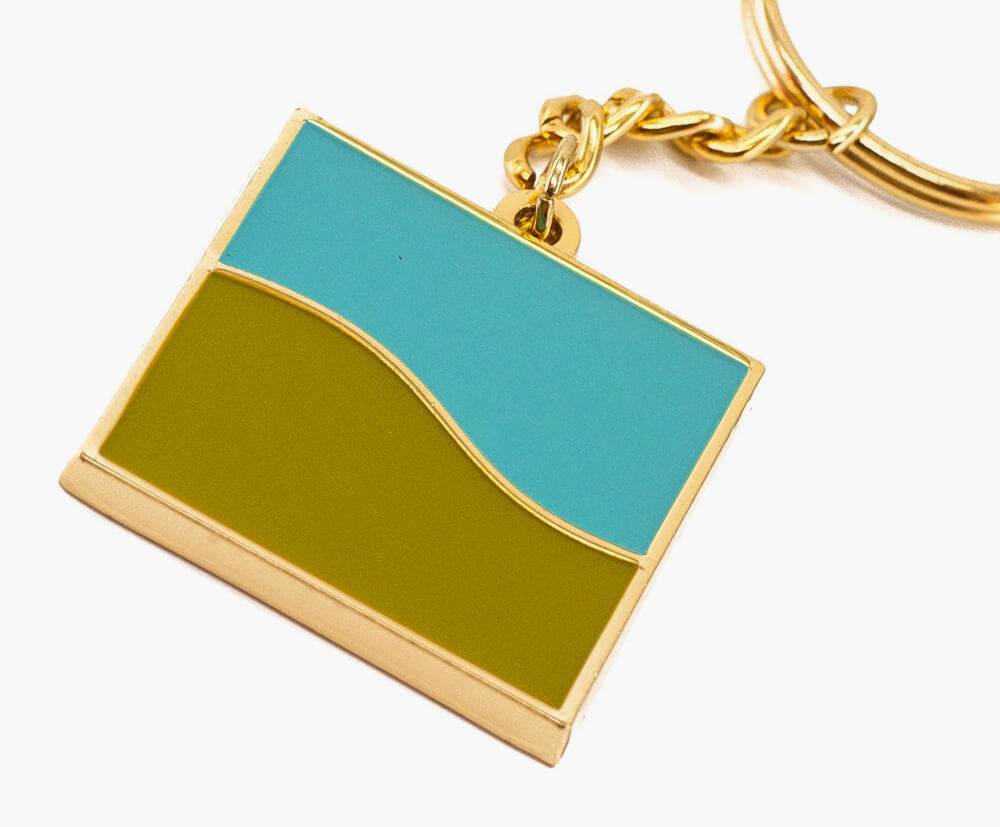 Gold plated custom shaped metal keyring with 2 colour enamel fill.