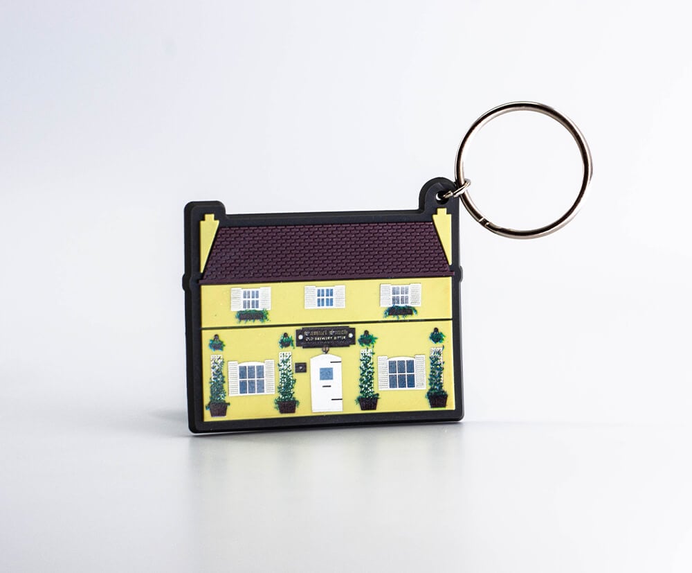 This house shaped PVC keyring has 3 colour pvc fill and then full colour print for the fine details (printed onto the yellow layer).