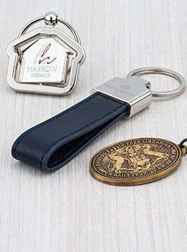 A group of 3 luxury metal keyrings in custom shapes