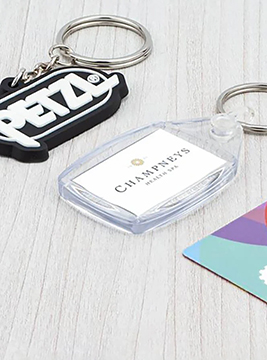 A group of plastic keyrings customised with business logos